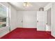 Cozy bedroom with bright window, classic trim, ceiling fan, and red carpeting at 2146 Federal Blvd, Denver, CO 80211