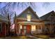 Charming two-story red brick home with a covered porch and classic architectural details at dusk at 2146 Federal Blvd, Denver, CO 80211