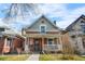 Charming brick home featuring a welcoming front porch and classic architectural details at 2146 Federal Blvd, Denver, CO 80211