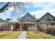 Charming two-story red brick home with a covered front porch and walkway at 2146 Federal Blvd, Denver, CO 80211