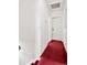 Narrow hallway featuring red carpeting and traditional white trim at 2146 Federal Blvd, Denver, CO 80211