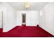 Neutral room featuring white walls, bright red carpeting and a decorative chandelier at 2146 Federal Blvd, Denver, CO 80211