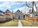 Exterior view of a fenced yard with a walkway to the home's entrance at 2146 Federal Blvd, Denver, CO 80211