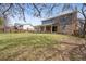 Large backyard with a spacious lawn, mature trees, and a covered patio, perfect for outdoor enjoyment at 4653 Kirkwood St, Boulder, CO 80301