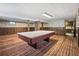 Wide shot of a large basement area with a pool table and unique wallpaper at 4653 Kirkwood St, Boulder, CO 80301