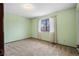 Bedroom with neutral carpet, window, and light green walls at 4653 Kirkwood St, Boulder, CO 80301