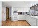Clean kitchen with white cabinets and appliances, featuring sleek countertops at 4653 Kirkwood St, Boulder, CO 80301