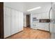 Well-lit kitchen with ample storage, white appliances, and wood-look flooring at 4653 Kirkwood St, Boulder, CO 80301