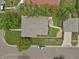 Aerial view of a home with a well-manicured yard, detached garage, and a charming patio area at 1600 Olive St, Denver, CO 80220