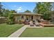 Beautiful backyard featuring a deck, lounge chairs, grill, and green grass at 1600 Olive St, Denver, CO 80220