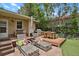 Lovely backyard patio with lounge chairs, outdoor dining set, and a built-in grill at 1600 Olive St, Denver, CO 80220