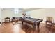 Basement with a pool table, lounge area, and wood floors, perfect for entertaining at 1600 Olive St, Denver, CO 80220