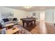 Finished basement with a pool table, sitting area, wood floors, and ample space at 1600 Olive St, Denver, CO 80220