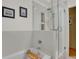 A modern bathroom featuring a soaking tub and glass-enclosed shower with tiled walls and tiled niche at 1600 Olive St, Denver, CO 80220