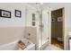 Modern bathroom featuring a shower with glass door, tub, and tile details at 1600 Olive St, Denver, CO 80220