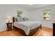 Bright bedroom with wood floors, two windows, and a comfortable queen-size bed at 1600 Olive St, Denver, CO 80220