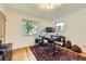 Bright bedroom featuring hardwood floors, two windows, and a work space with a monitor at 1600 Olive St, Denver, CO 80220