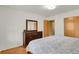 Bedroom with wood floors, neutral colors, and closet for storage at 1600 Olive St, Denver, CO 80220