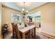 Inviting dining room with hardwood floors, natural light, and an adjacent living area at 1600 Olive St, Denver, CO 80220
