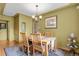 Charming dining room featuring a wooden table with seating for four and elegant light fixture at 1600 Olive St, Denver, CO 80220