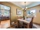 Dining room with hardwood floors, natural light, access to a kitchen and featuring a classic chandelier at 1600 Olive St, Denver, CO 80220