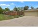 Long driveway leading to a two-car garage with beautiful landscaping at 1600 Olive St, Denver, CO 80220