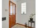 Classic entryway with a beautiful wood door, decorative glass, and stylish tile flooring at 1600 Olive St, Denver, CO 80220