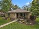 Charming brick home featuring a cozy front porch and a well-maintained, landscaped yard at 1600 Olive St, Denver, CO 80220