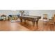 Spacious game room with pool table, laminate floors and comfortable seating area for entertaining at 1600 Olive St, Denver, CO 80220