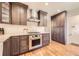 Modern kitchen with stainless steel appliances, custom cabinets, and hardwood floors at 1600 Olive St, Denver, CO 80220
