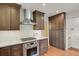 Modern kitchen featuring stainless steel appliances, brown wood cabinets, and herringbone-patterned backsplash at 1600 Olive St, Denver, CO 80220