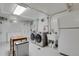 Bright laundry room with modern washer and dryer units and ample storage at 1600 Olive St, Denver, CO 80220