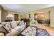 Spacious living room with hardwood floors, neutral decor, and access to the dining area at 1600 Olive St, Denver, CO 80220