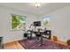 Home office with a standing desk, dual monitors, hardwood floors, and natural light at 1600 Olive St, Denver, CO 80220