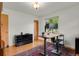 Home office featuring a standing desk, dual monitors, hardwood floors, and natural light at 1600 Olive St, Denver, CO 80220