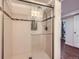 Updated shower with mosaic tile accents and a sleek glass door at 1600 Olive St, Denver, CO 80220