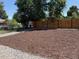 Large backyard space with rock and mulch landscaping and a wood fence offering privacy and potential for outdoor enjoyment at 2510 Kenton, Aurora, CO 80010