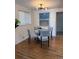 Cozy dining area featuring a modern light fixture, glass table, and comfortable seating for four guests at 2510 Kenton, Aurora, CO 80010