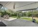 Covered back patio with dining set overlooking a lush backyard and shed at 3179 S University Blvd, Englewood, CO 80113