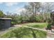 Landscaped backyard with shed, raised garden beds, and green lawn at 3179 S University Blvd, Englewood, CO 80113