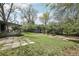Large backyard featuring mature trees, shed, garden beds, and a patio at 3179 S University Blvd, Englewood, CO 80113