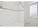Bright bathroom featuring white subway tiles and a window providing natural light at 3179 S University Blvd, Englewood, CO 80113
