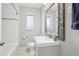 Updated bathroom with subway tile, shower and gray vanity with an ornate mirror at 3179 S University Blvd, Englewood, CO 80113