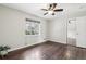 Bedroom features hardwood floors, closet with mirror doors and a large window at 3179 S University Blvd, Englewood, CO 80113