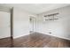 Bedroom featuring hardwood floors, mirrored closet and a large window at 3179 S University Blvd, Englewood, CO 80113
