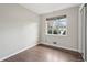 Cozy bedroom with hardwood floors and a window offering a pleasant outdoor view at 3179 S University Blvd, Englewood, CO 80113