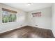 Bright bedroom with hardwood floors, two windows and neutral paint throughout at 3179 S University Blvd, Englewood, CO 80113