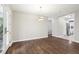 Bright dining room boasts hardwood floors and a contemporary chandelier, with an adjacent kitchen at 3179 S University Blvd, Englewood, CO 80113