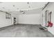 Spacious garage with concrete floor, storage shelving, and garage door opener at 3179 S University Blvd, Englewood, CO 80113