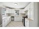 Bright kitchen with white cabinets, stainless steel appliances, and a window over the sink at 3179 S University Blvd, Englewood, CO 80113